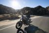 A motorcycle being ridden along a canyon road