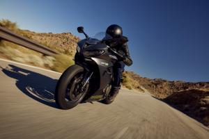 A sports bike riding along a canyon road